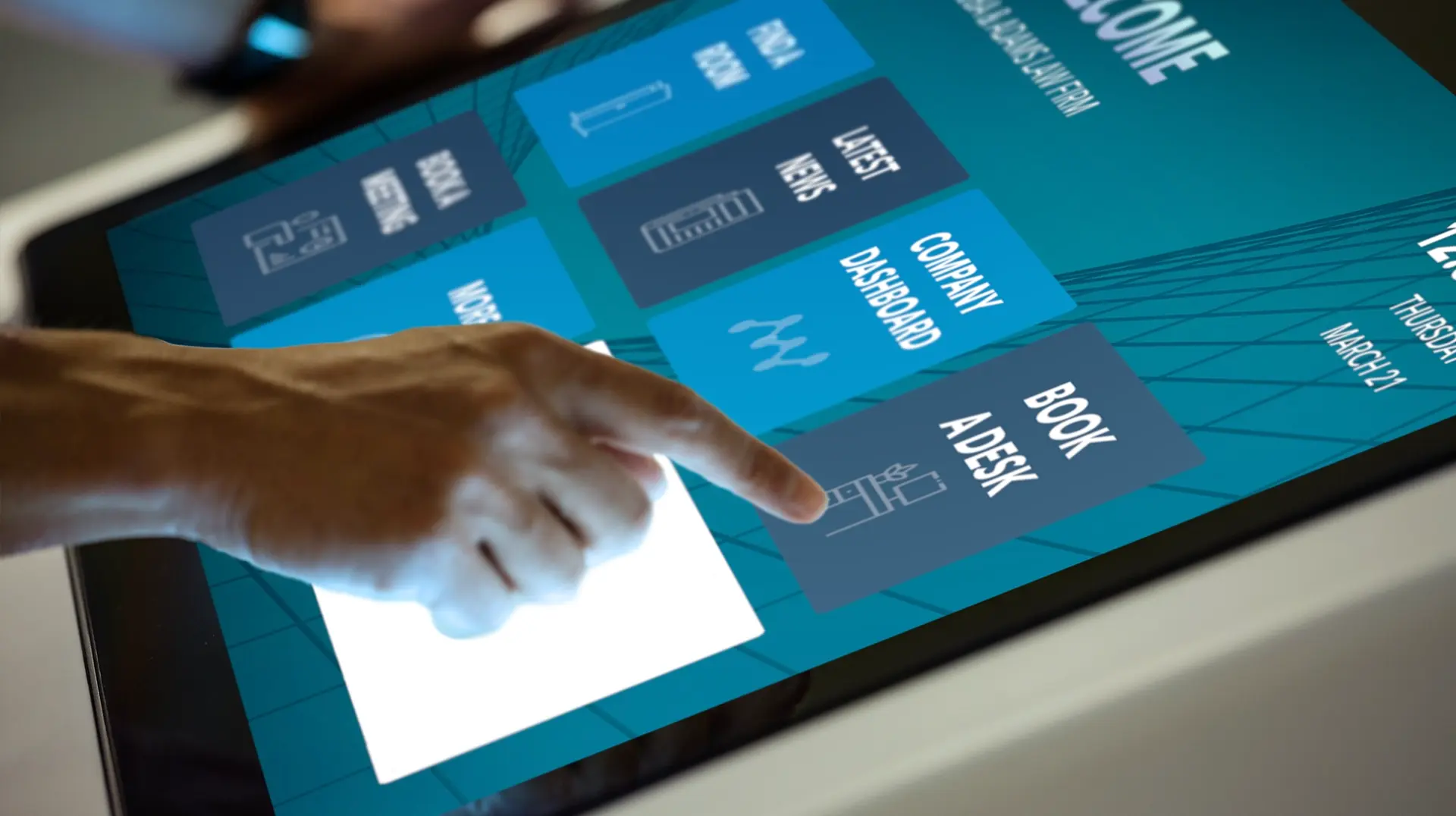 Interactive Display in Use Close-up of a hand interacting with Elo touchscreen display to book a desk at the office